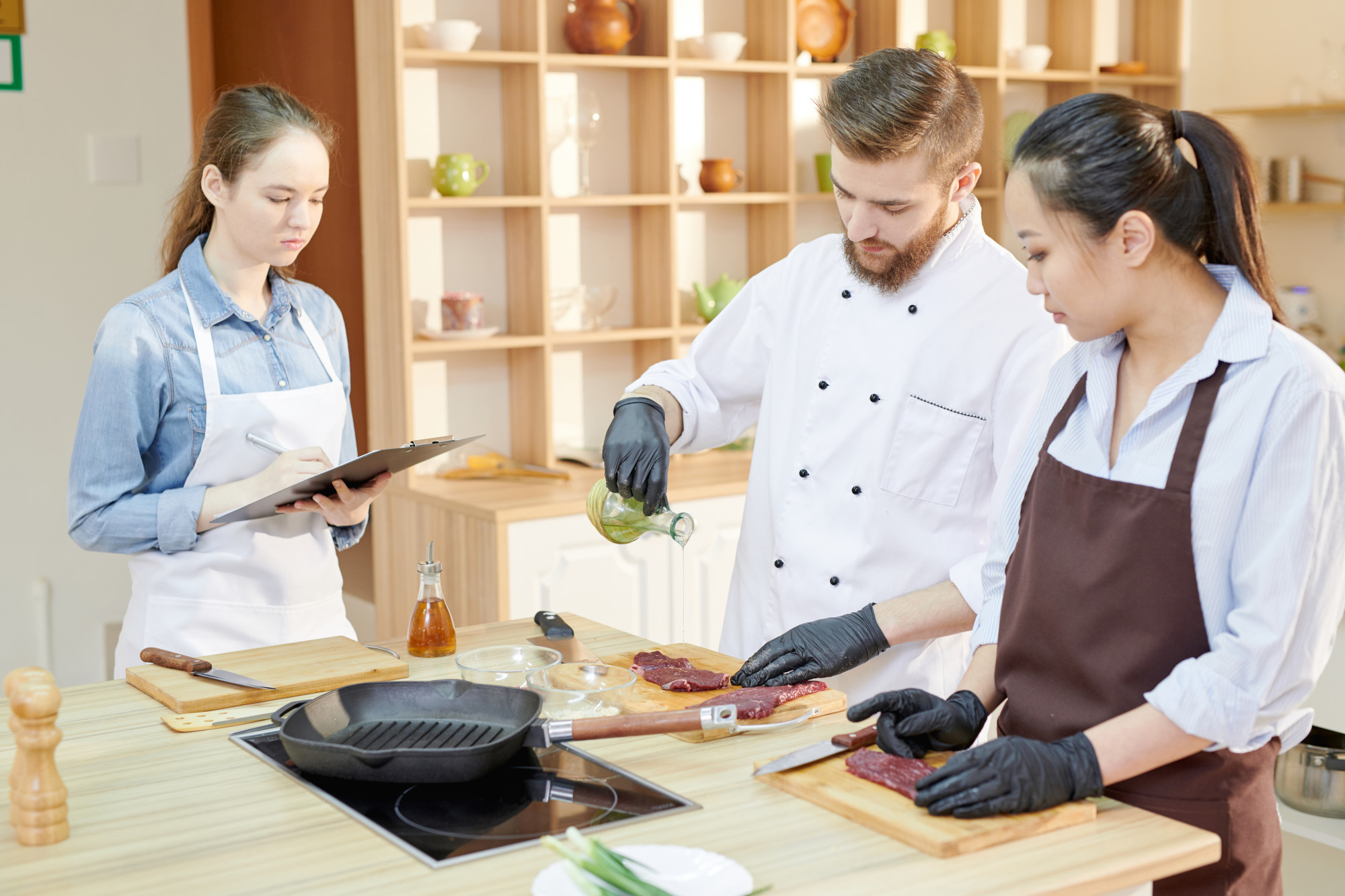 chef mentoring junior cook in small kitchen